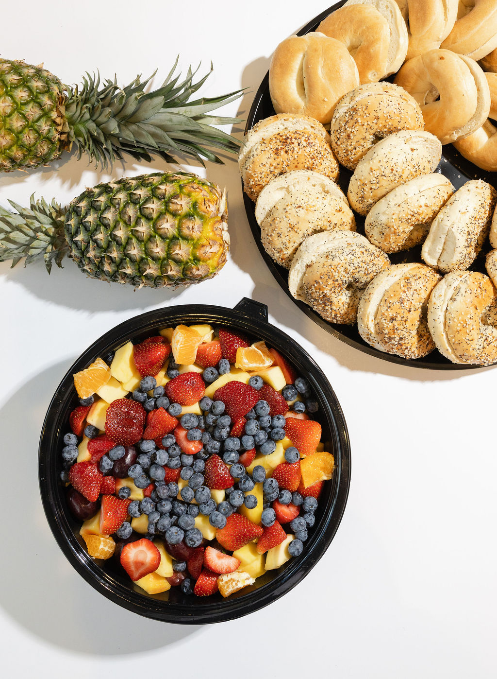Comfort Fuel catering spread — bagel platter and fresh fruit